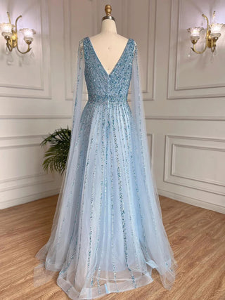 Desert Mirage: Dubai-Inspired Nude Evening Gown with Cape Sleeves Accented in Elegant Blue - A Vision of Grace for Weddings and Celebrations.