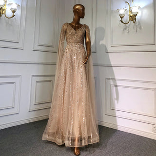 Desert Mirage: Dubai-Inspired Nude Evening Gown with Cape Sleeves Accented in Elegant Blue - A Vision of Grace for Weddings and Celebrations.