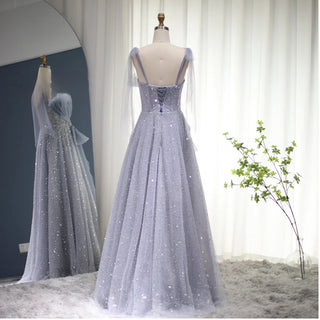Dubai Dawn: Blush Pink Gown with Elegant Blue Accents and Spaghetti Straps for Wedding Formals.