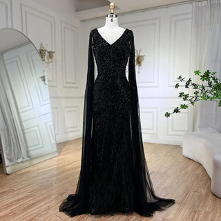 Midnight Majesty: 2024 Black Mermaid Evening Gown with Cape Sleeves and High Split - Luxury Beaded Feathers Dress for Women's Party